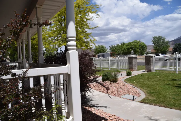 Front porch with turned columns and a white railing