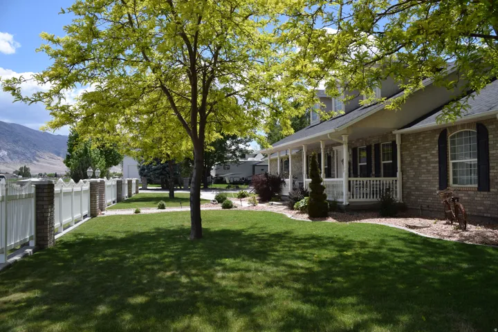 Brick façade home with a covered front porch featuring white railings