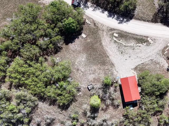 Rural acreage with multiple structures and natural landscaping