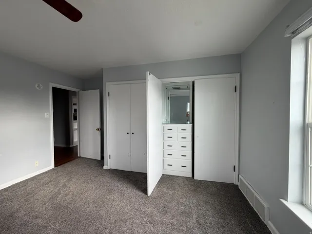 Built-in closet system with mirrored storage and multiple drawers