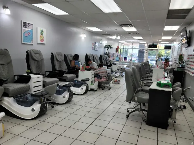 Commercial space featuring multiple pedicure stations, individual manicure stations, tile flooring, fluorescent ceiling lighting, and expansive storefront windows
