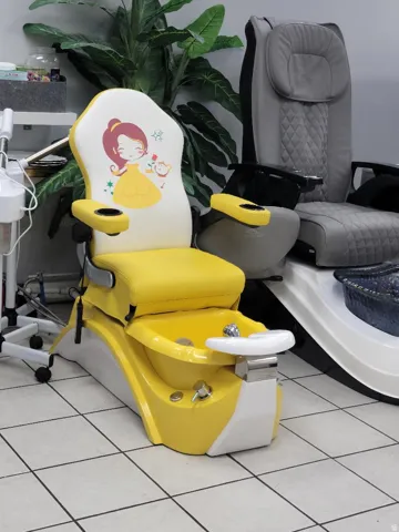 Yellow and white pedicure station featuring an integrated basin