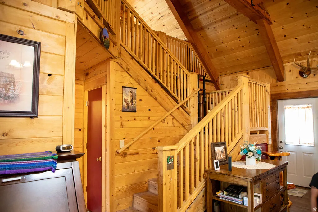 Multi-level interior featuring extensive wood paneling and exposed wood beams
