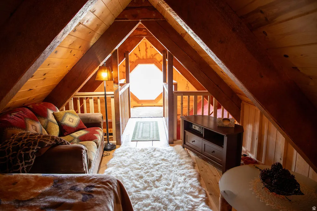 Exposed wood beams and plank walls define this loft space