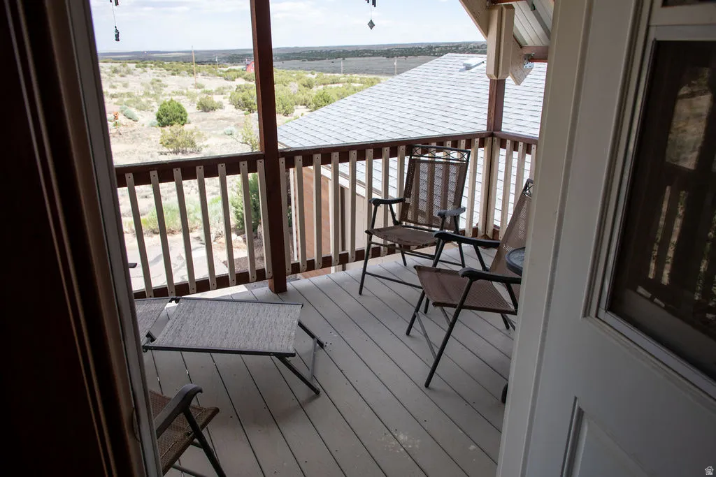 Elevated outdoor deck featuring composite decking and a wooden railing