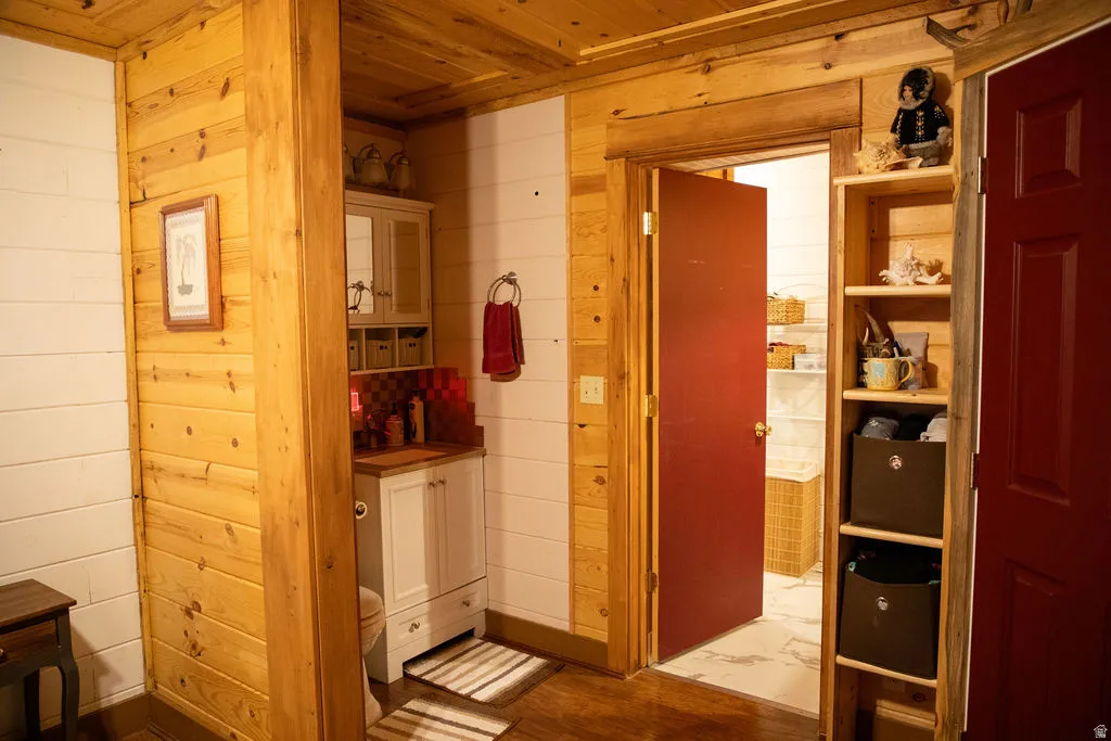 Rustic interior featuring natural wood paneling and white horizontal plank walls