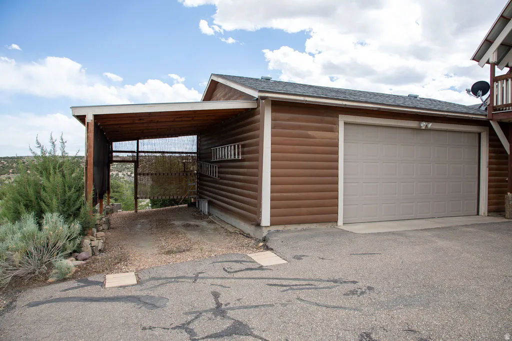 Attached two-car garage with a light gray panel door