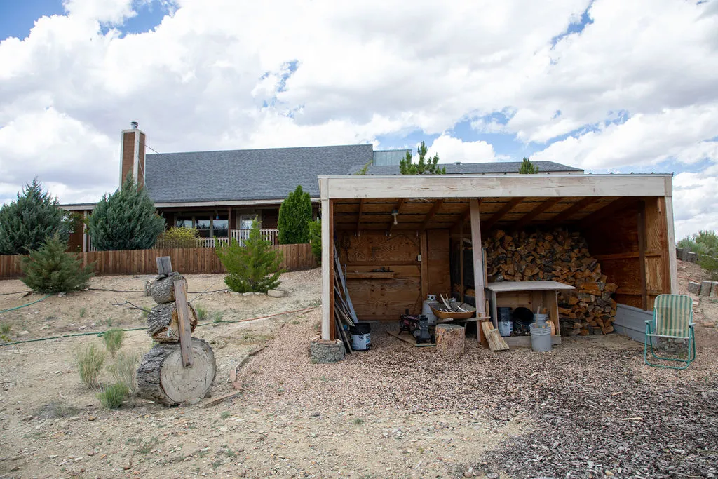 Wood-sided residence with an asphalt shingle roof and brick chimney
