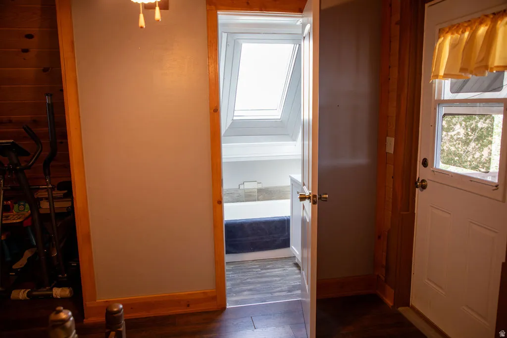 Doorway opening to a space with a skylight and white built-in cabinetry