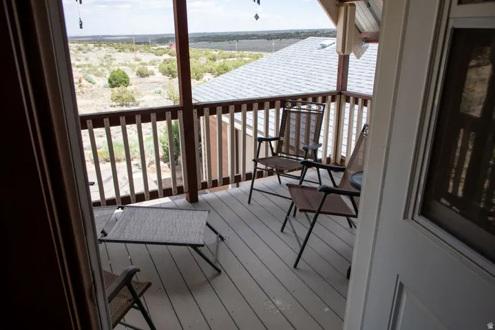 Elevated outdoor deck featuring composite decking and a wooden railing