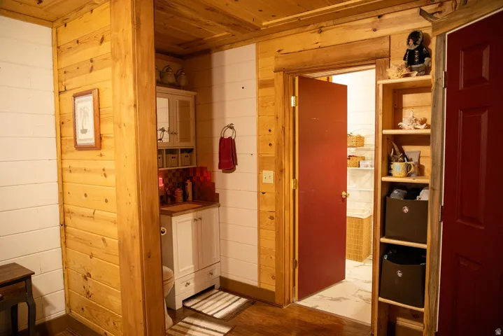 Rustic interior featuring natural wood paneling and white horizontal plank walls