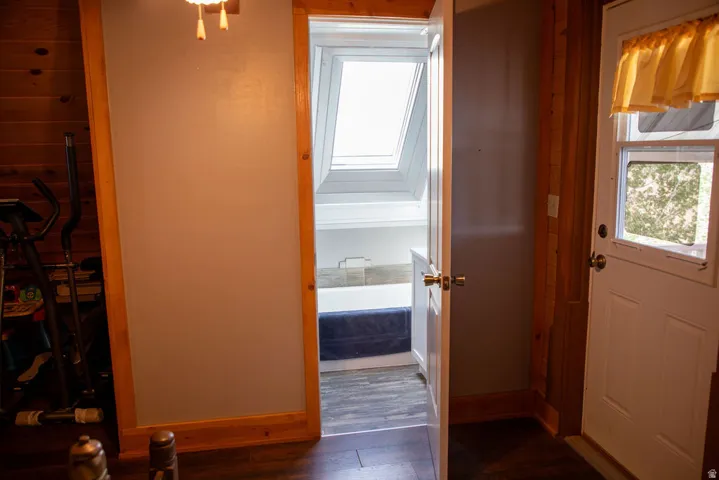 Doorway opening to a space with a skylight and white built-in cabinetry