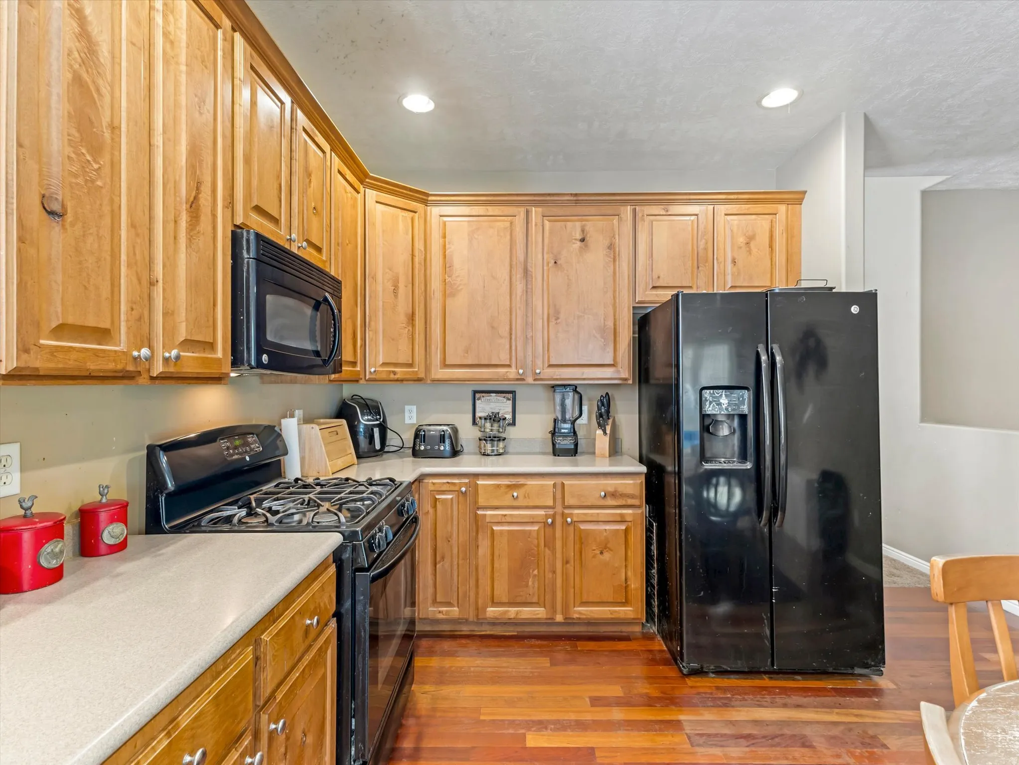 Kitchen featuring wood-finish flooring and extensive cabinetry