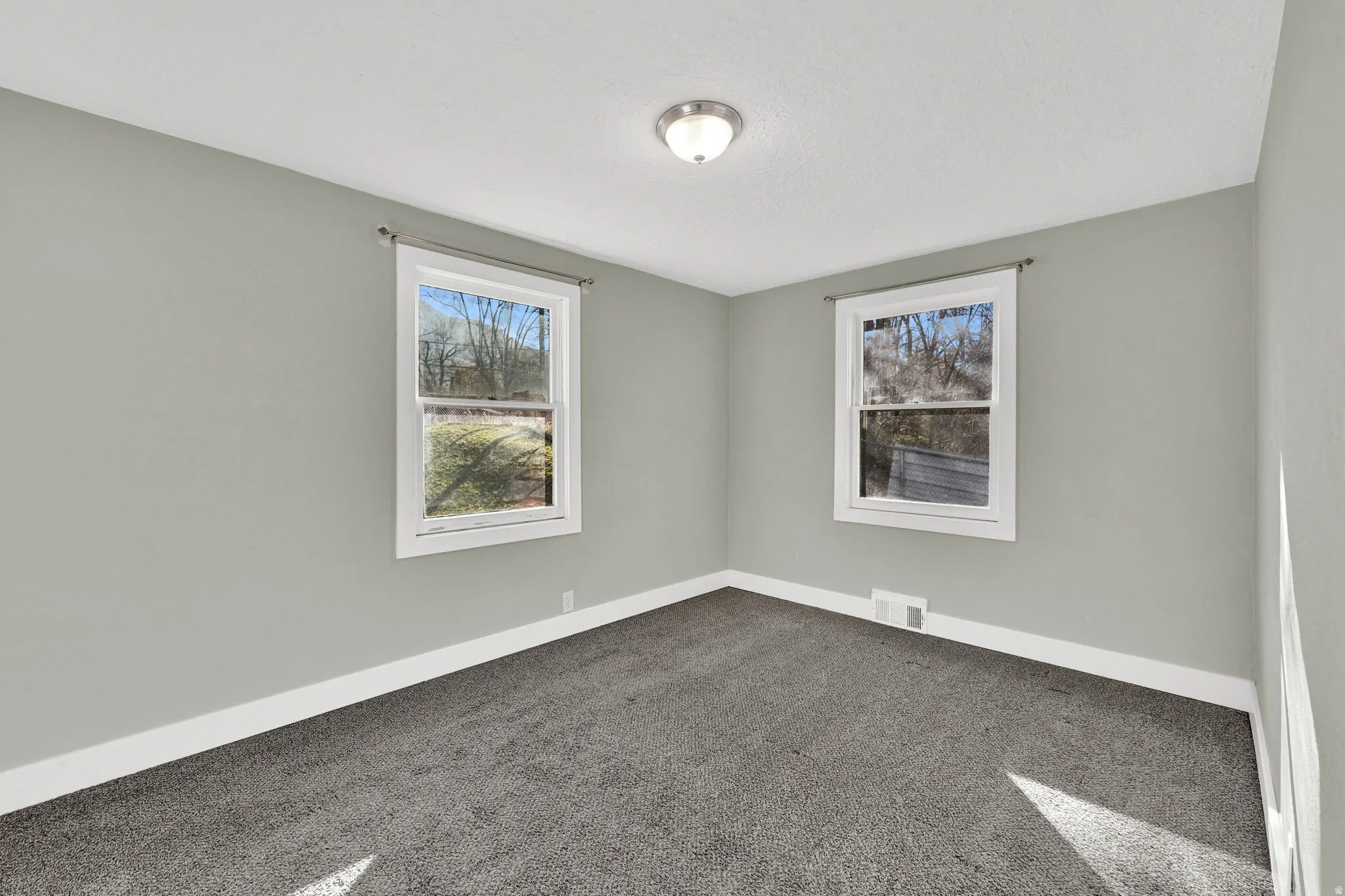 Light gray interior paint tones complement the dark gray carpeting