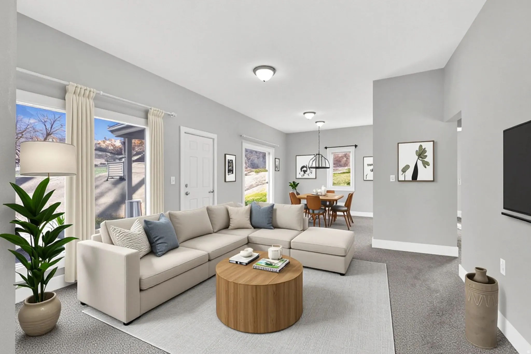 Open-concept living space featuring light gray walls, white trim, and recessed lighting