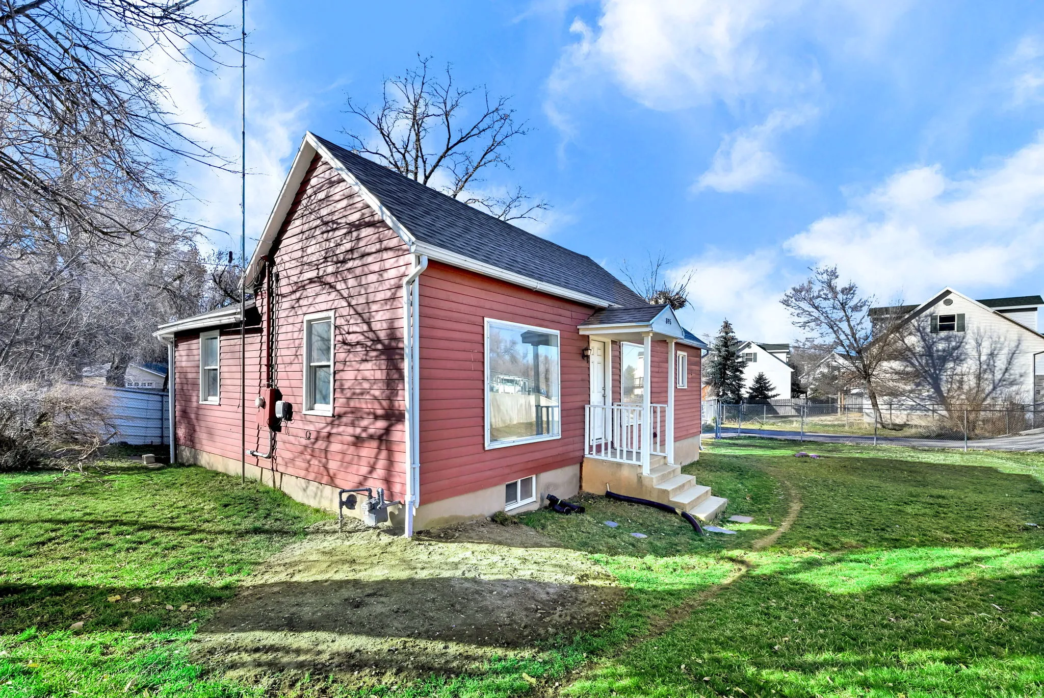 Red siding exterior with white trim
