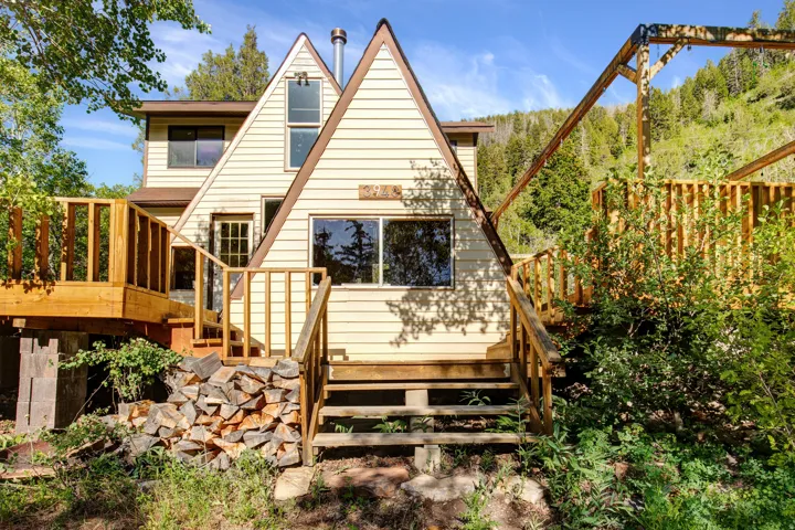 A-frame architectural style with light-toned siding and contrasting trim