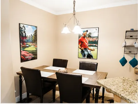 Dining area featuring a decorative chandelier with frosted glass shades and crown molding