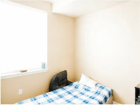 Room featuring light beige walls and a single window with a white sill
