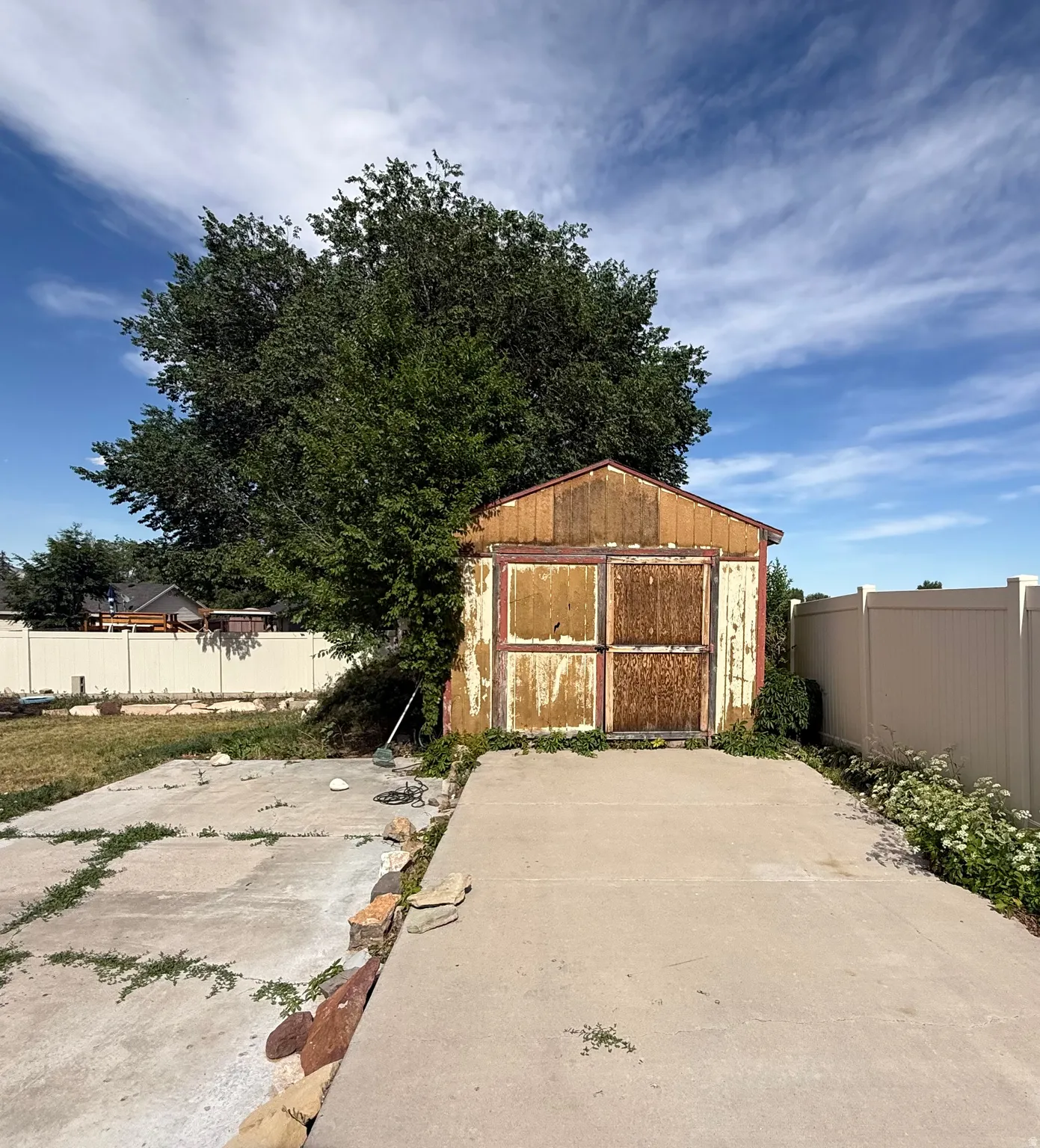 Freestanding shed structure with paneled double doors and a gabled roofline