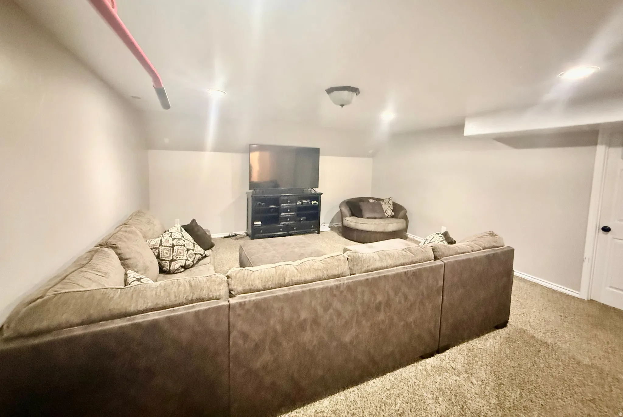 Carpeted room with recessed lighting and a flush-mount ceiling fixture