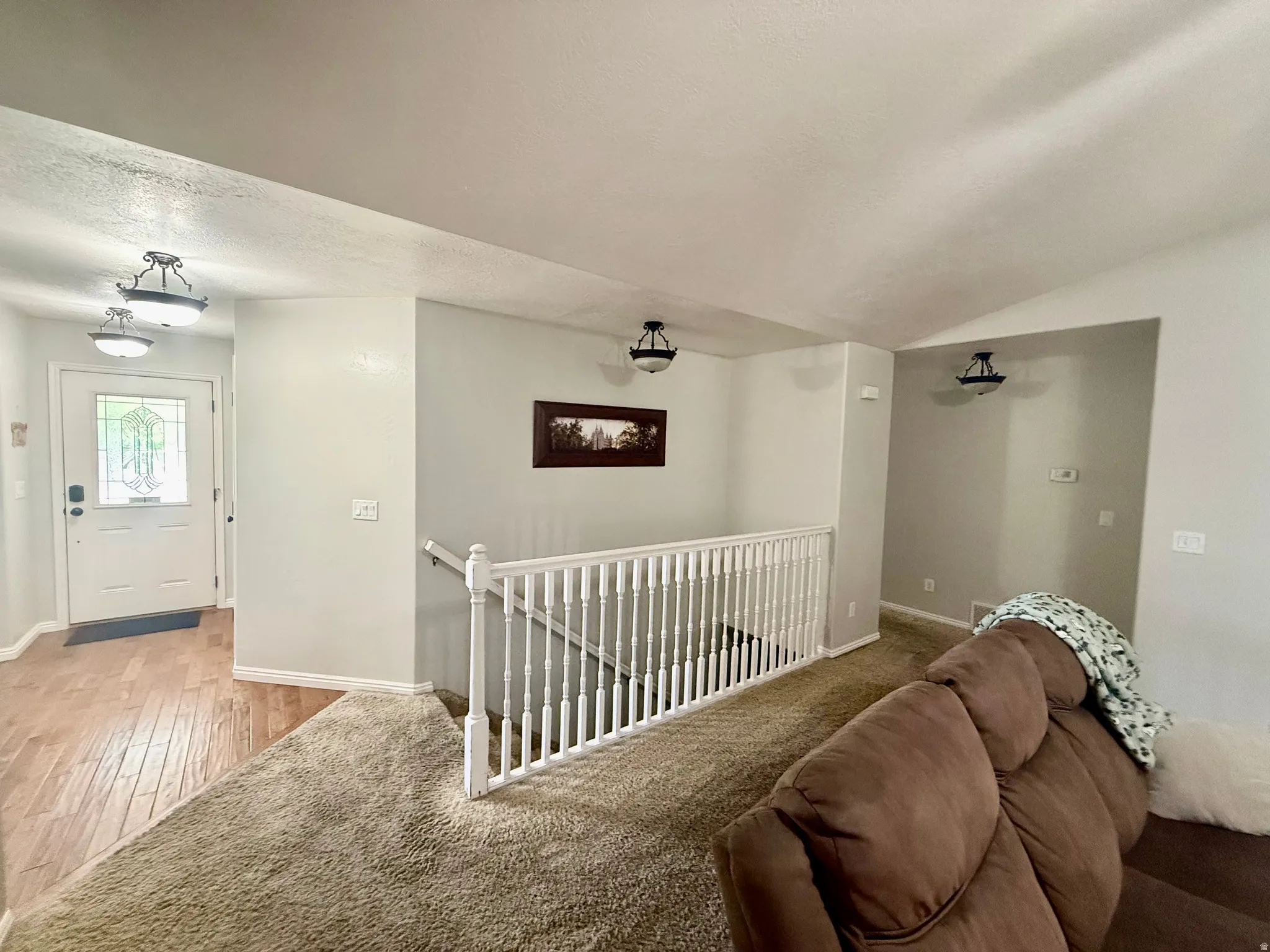 Entryway featuring wood-finish flooring, a decorative glass front door, and overhead flush-mount lighting