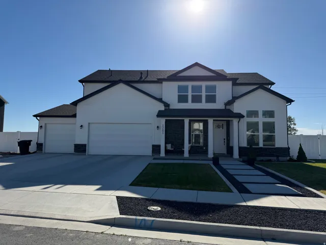Contemporary two-story exterior with white siding and dark trim accents