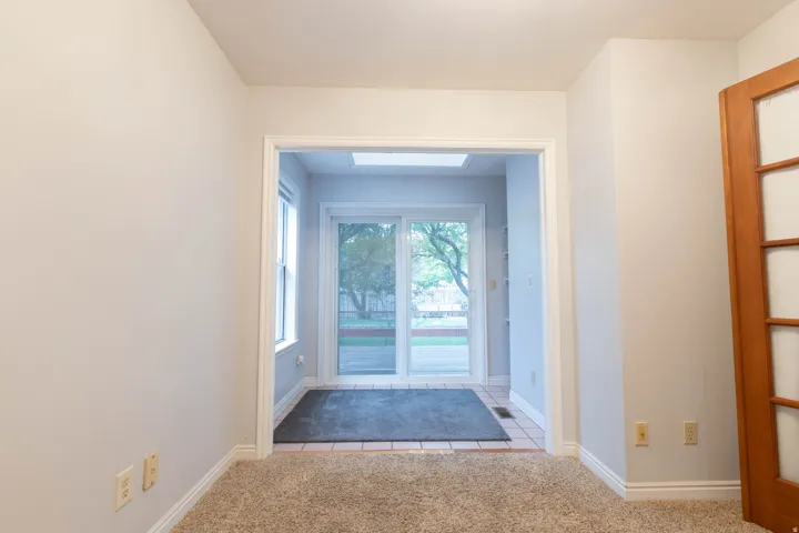 Carpeted room with light neutral walls and white trim