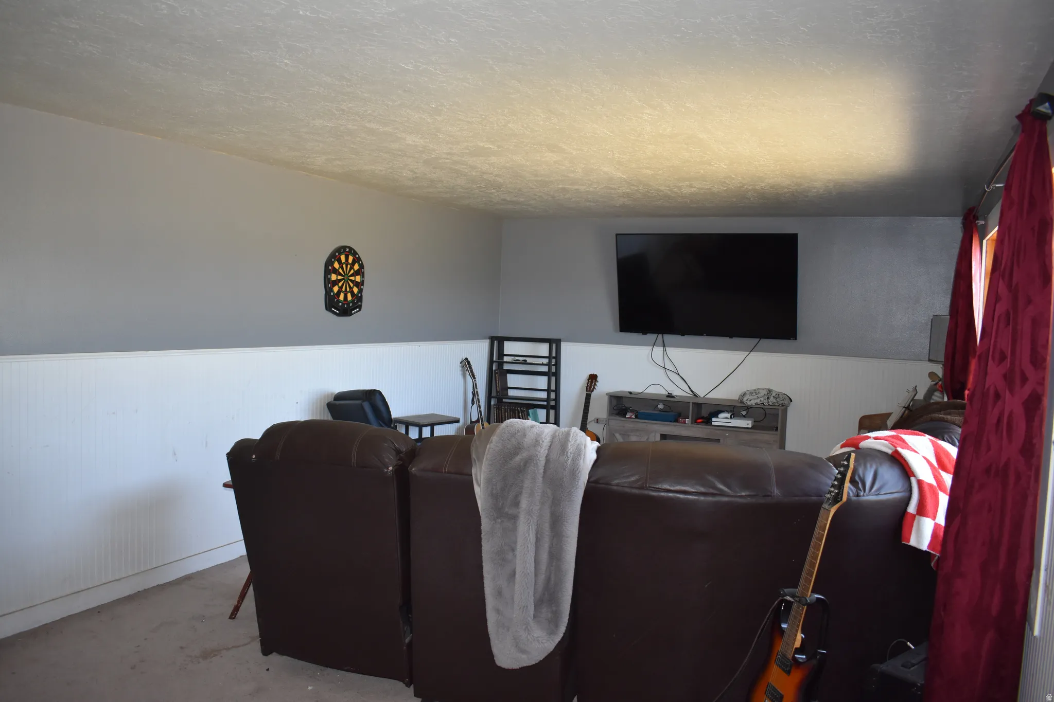 Recreation area featuring wainscoting, light gray wall paint, and carpeted flooring
