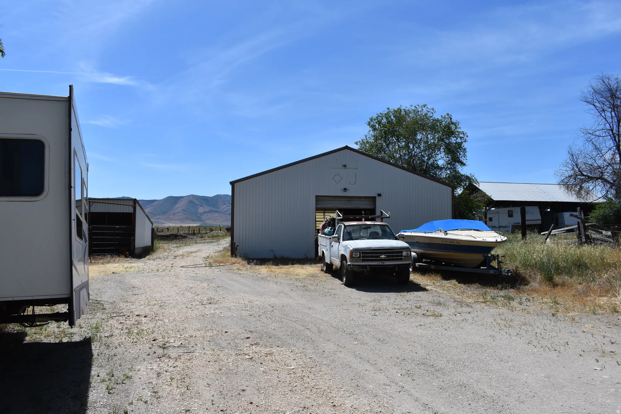 Metal-sided utility building with an open bay door