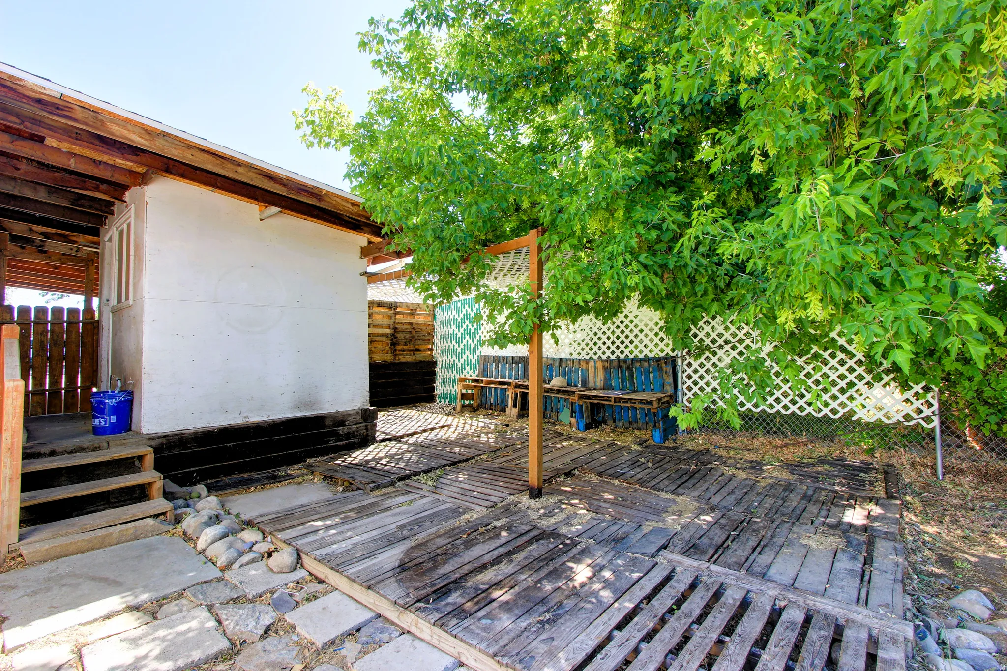Outdoor patio area featuring wood-finish decking and stone pavers