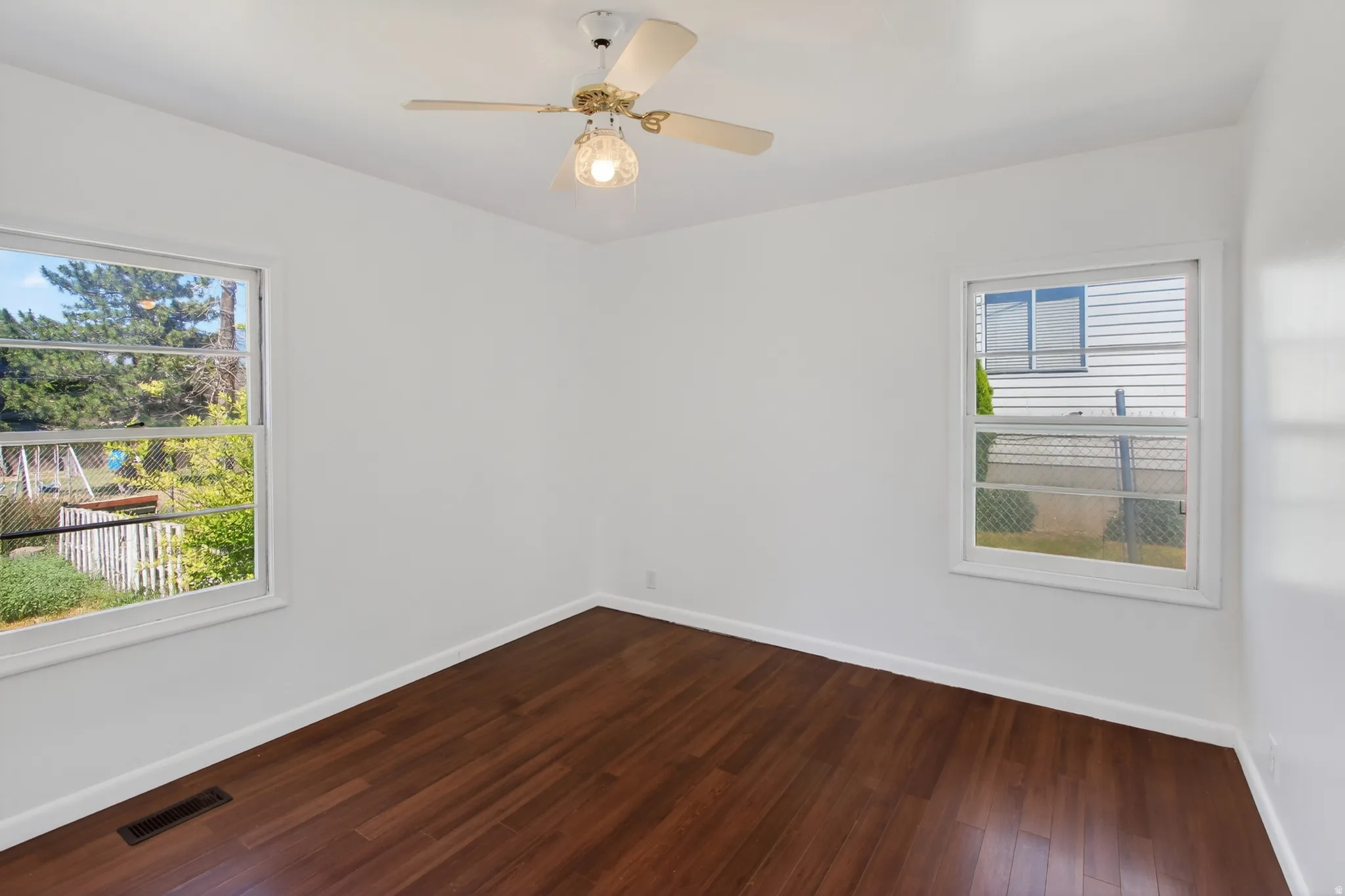 Bright interior space featuring wood-finish flooring, white walls, and white trim