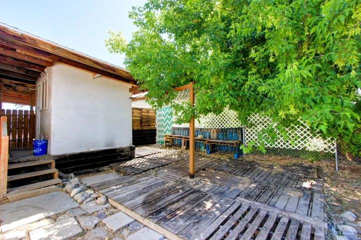 Outdoor patio area featuring wood-finish decking and stone pavers