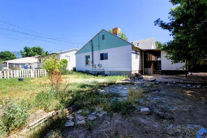 Rear exterior of a residence featuring white and blue siding