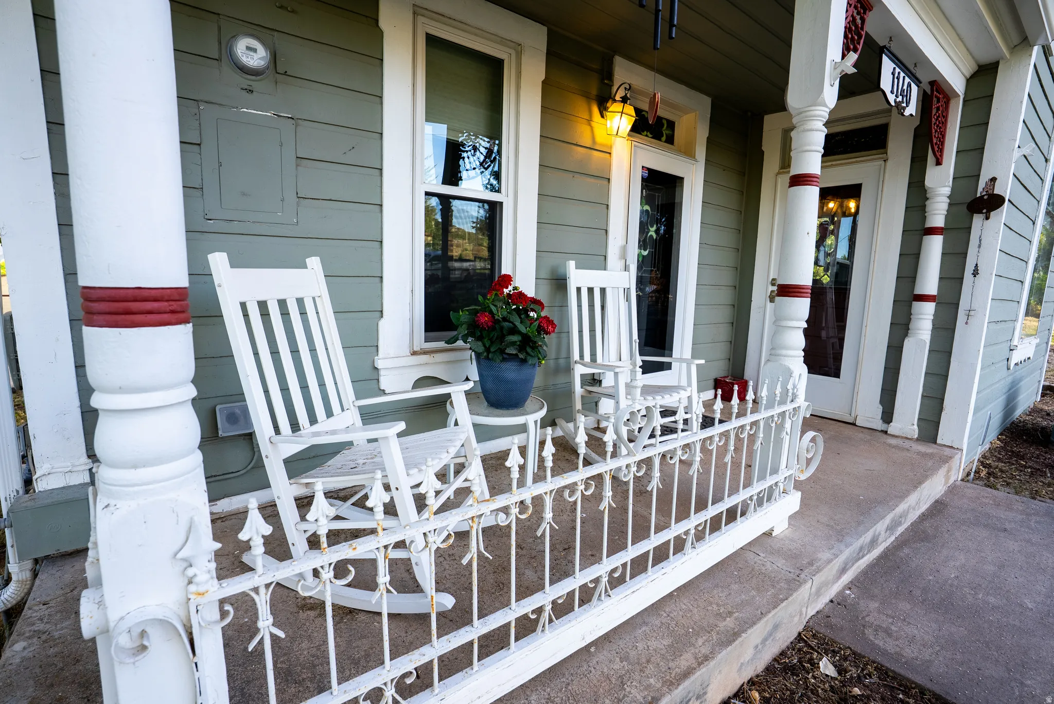 Front porch with decorative white railings and turned columns