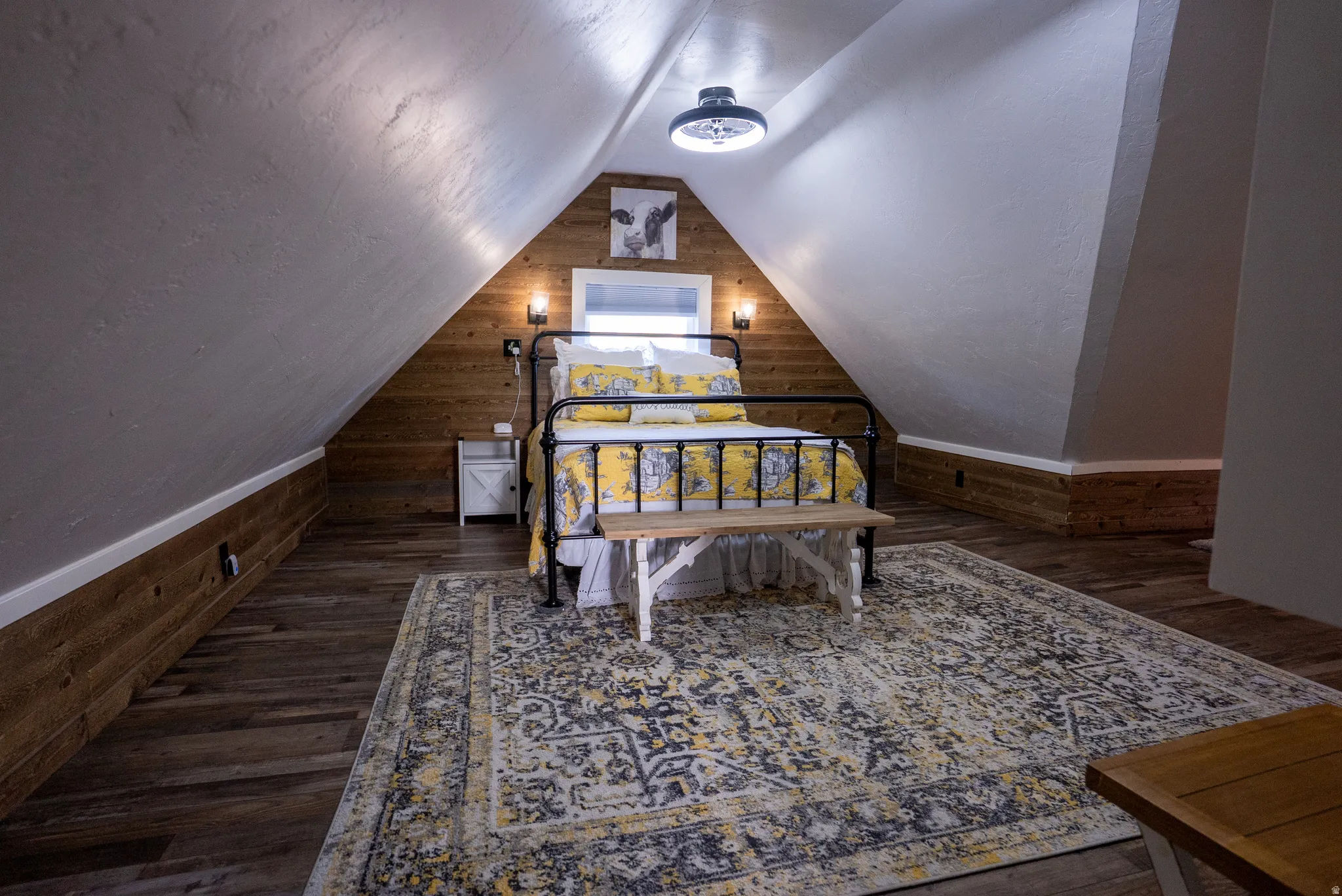 Room featuring sloped ceilings and wood-finish flooring