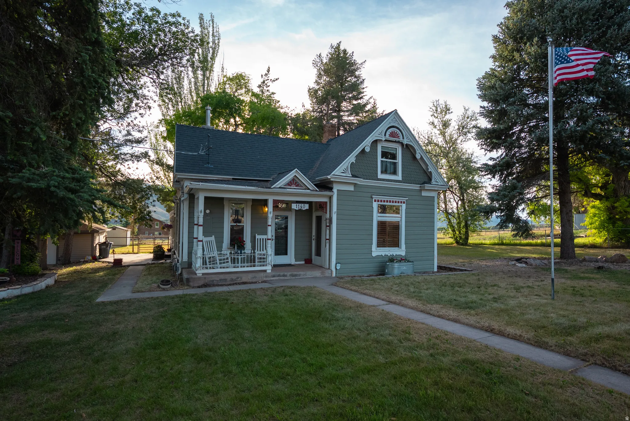 Traditional two-story exterior with a covered porch, gabled roofline, and dormer window