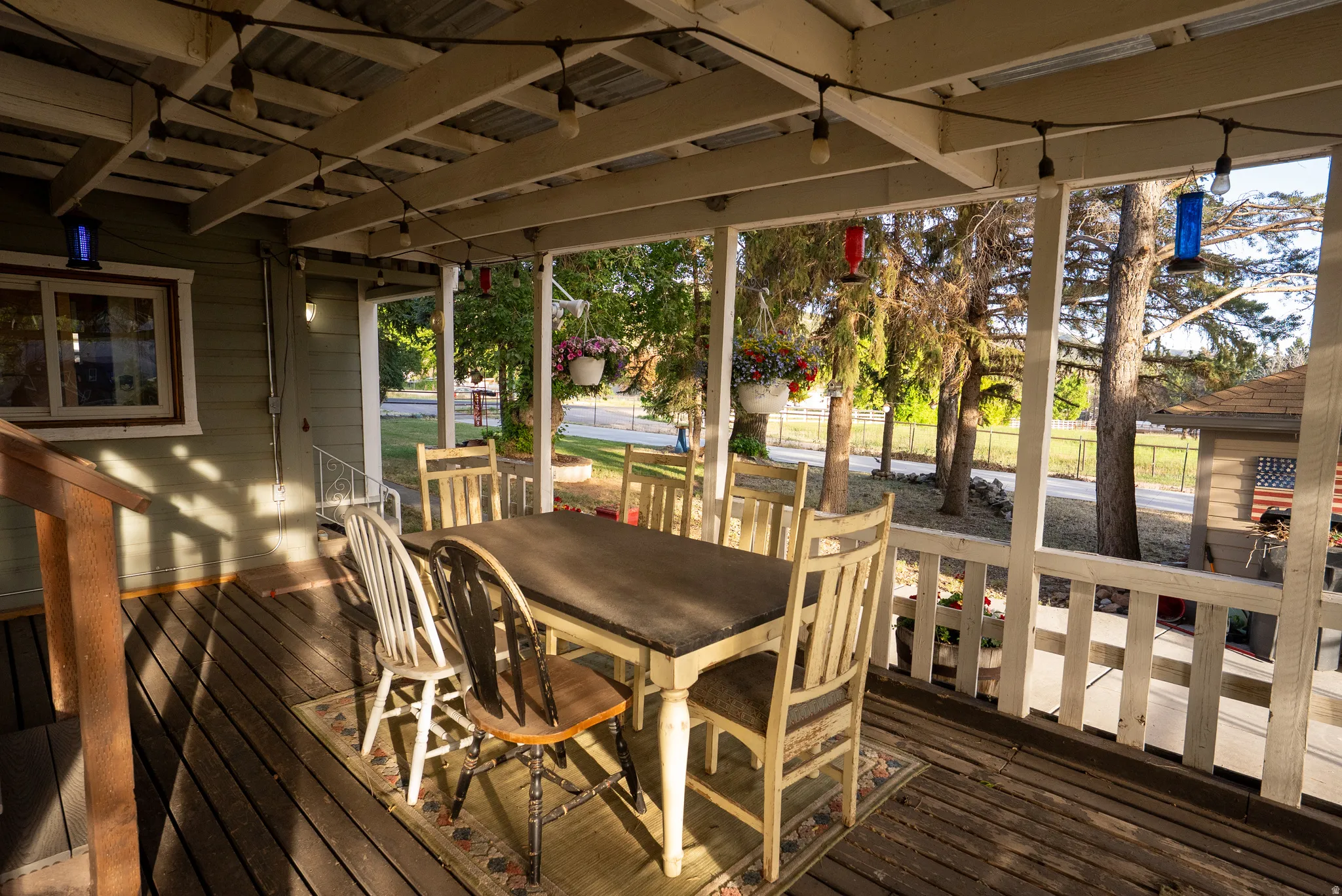 Covered outdoor patio featuring a corrugated metal roof and exposed wood beams
