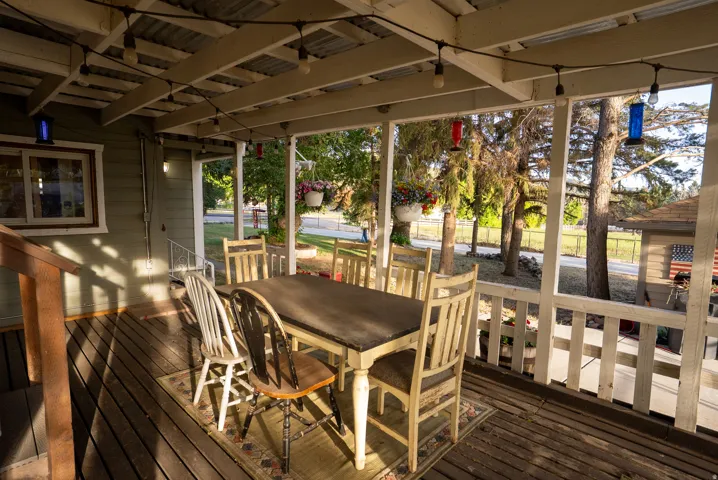 Covered outdoor patio featuring a corrugated metal roof and exposed wood beams