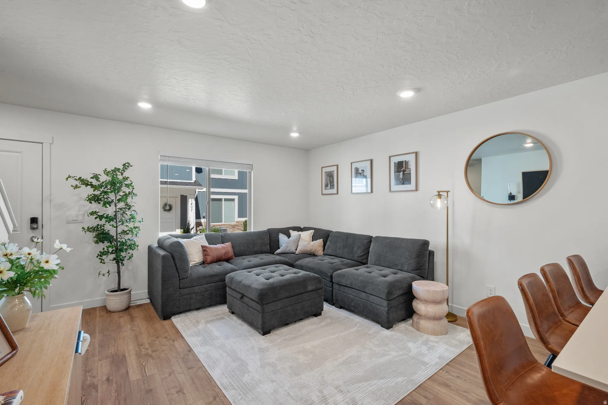 Living space featuring wood-finish flooring, white walls, and recessed lighting