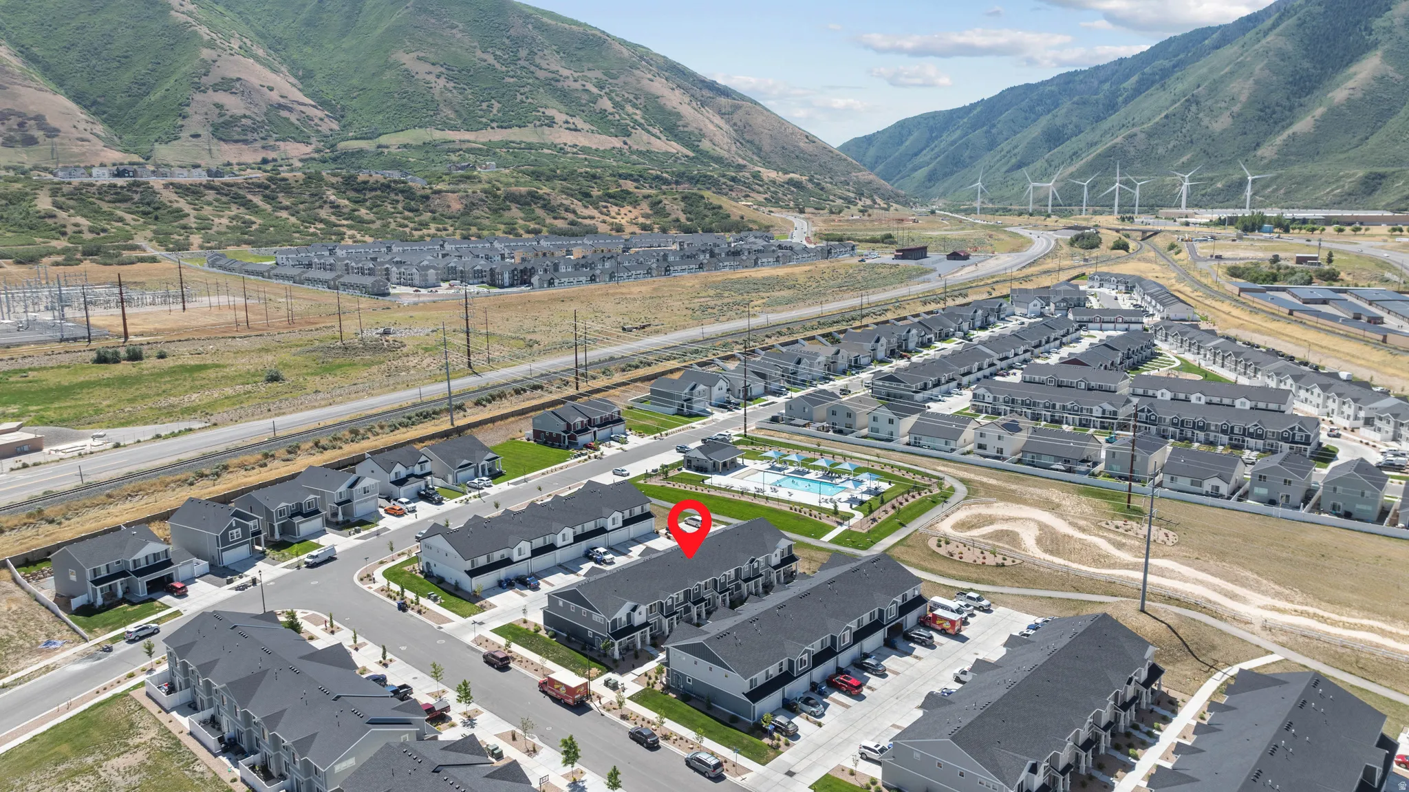 Aerial perspective showcasing a community of townhomes and single-family residences