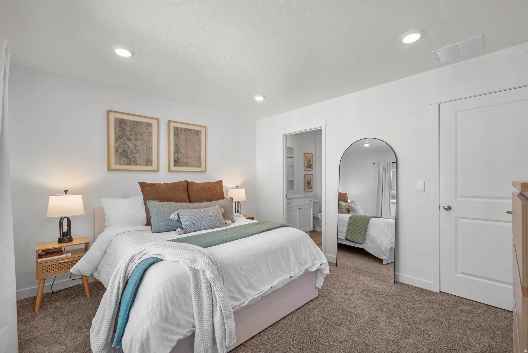 Bedroom featuring plush carpeting, recessed lighting, and a white paneled door