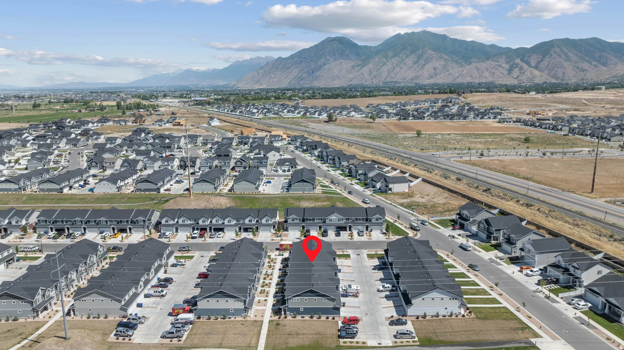 Aerial perspective showcasing a residential community with contemporary townhome and single-family home designs