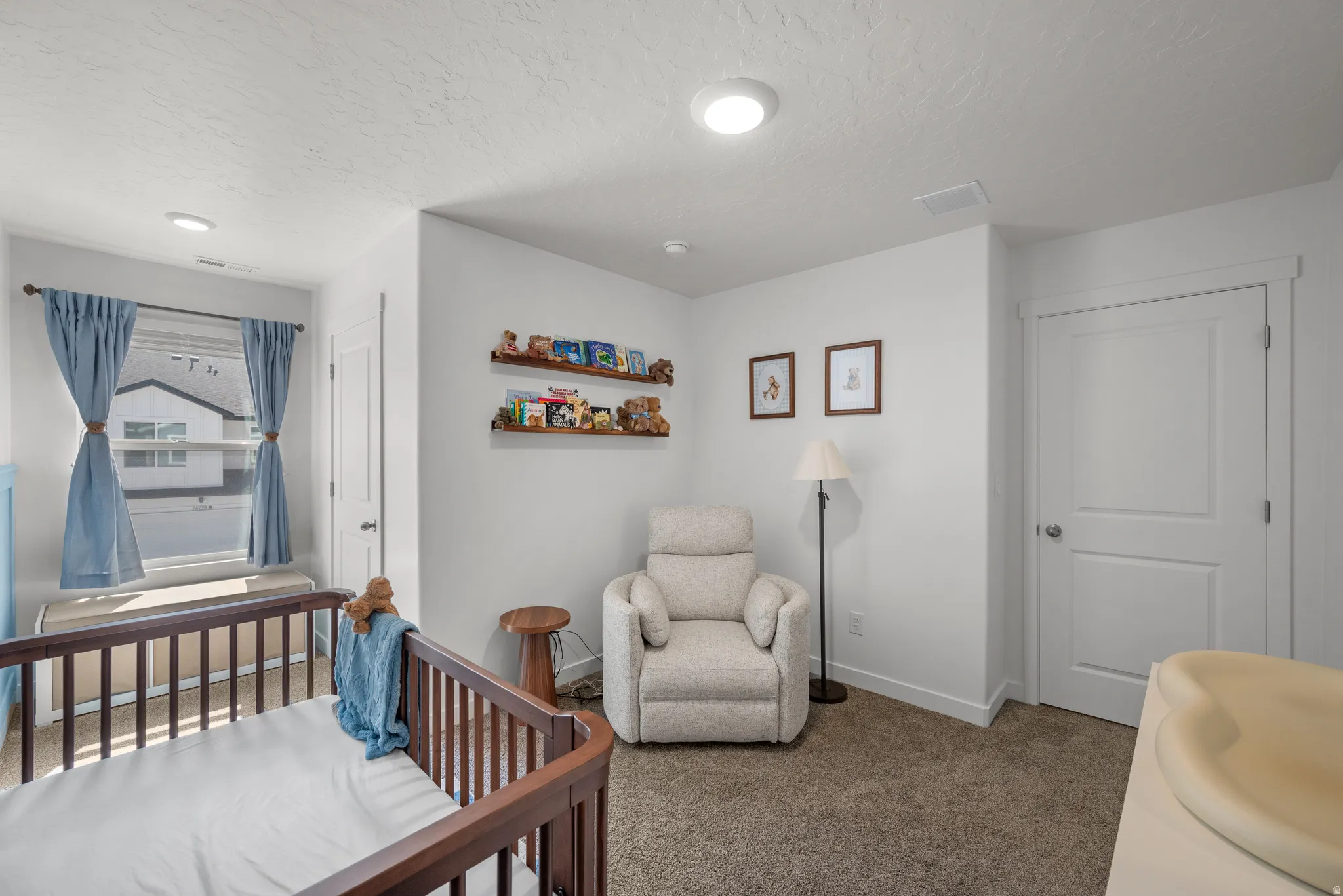 Carpeted interior space featuring a window with natural light, two-panel interior doors, and recessed ceiling lighting