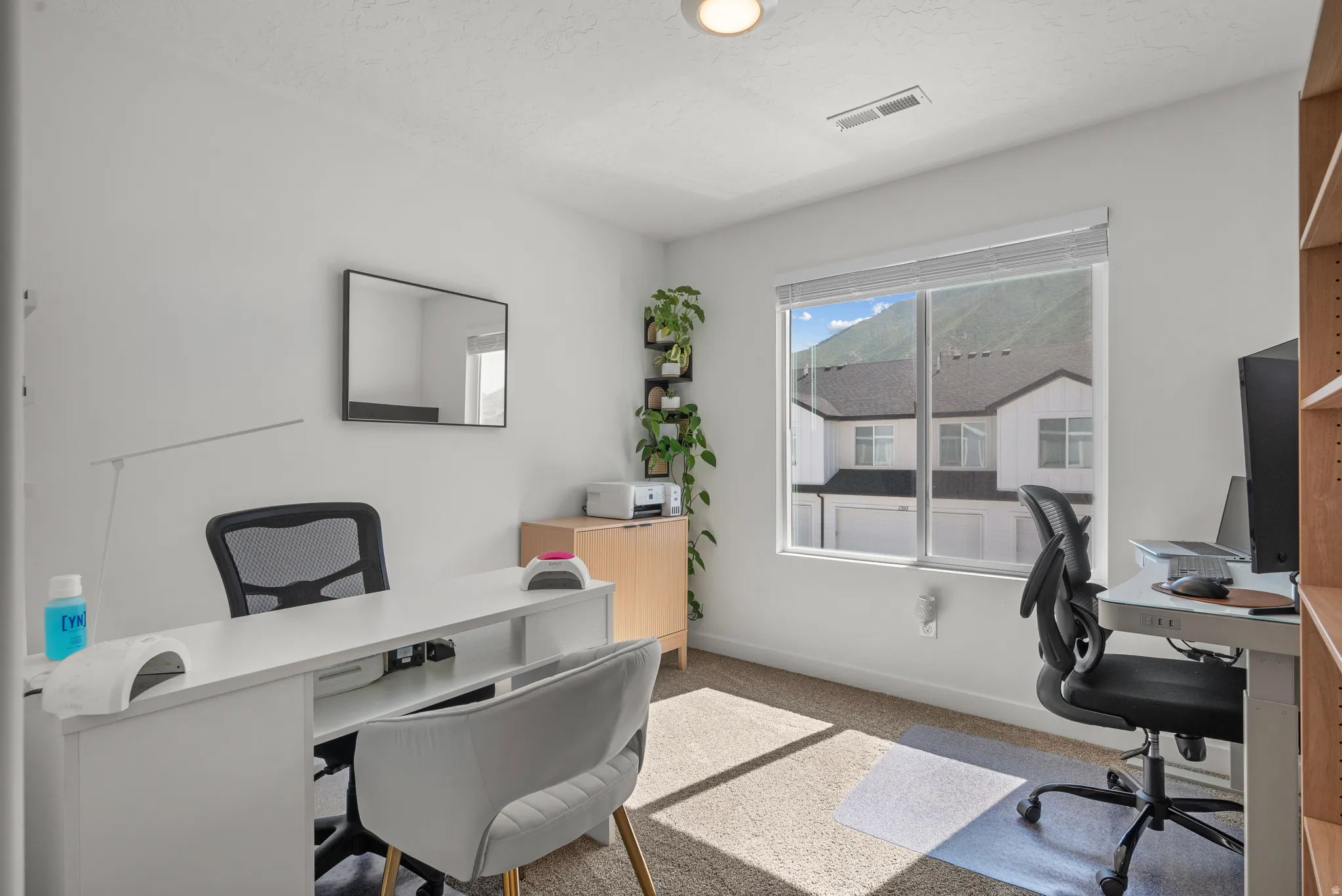 Bright room featuring neutral carpet flooring, a large window, and recessed ceiling lighting