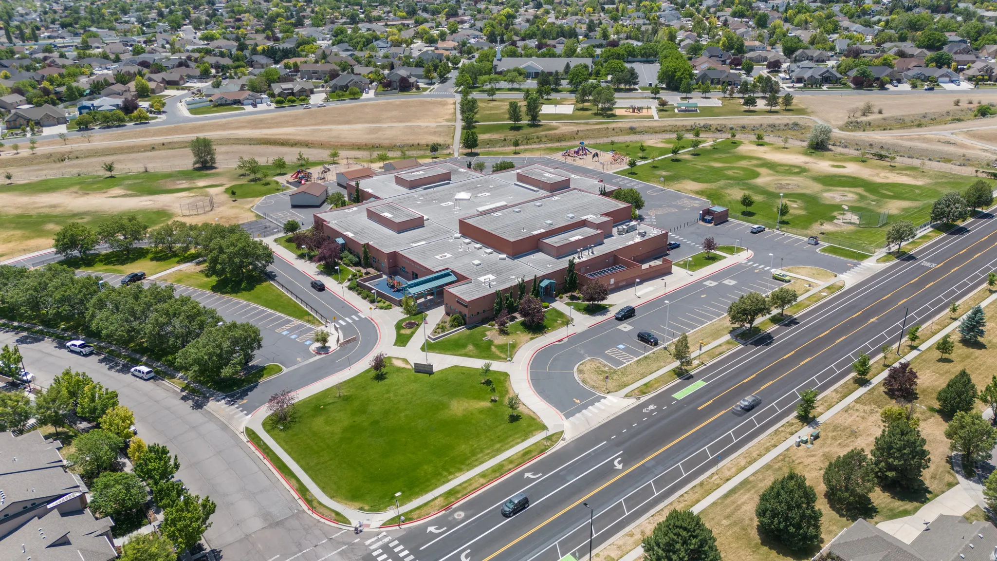 Expansive commercial property featuring a large brick-clad building with multiple wings and a flat roofline