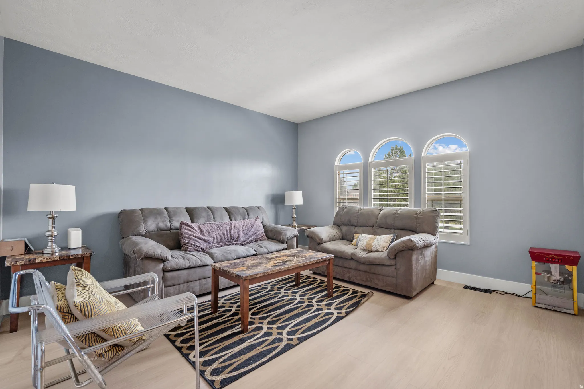 Light blue wall paint complements the light wood-finish flooring