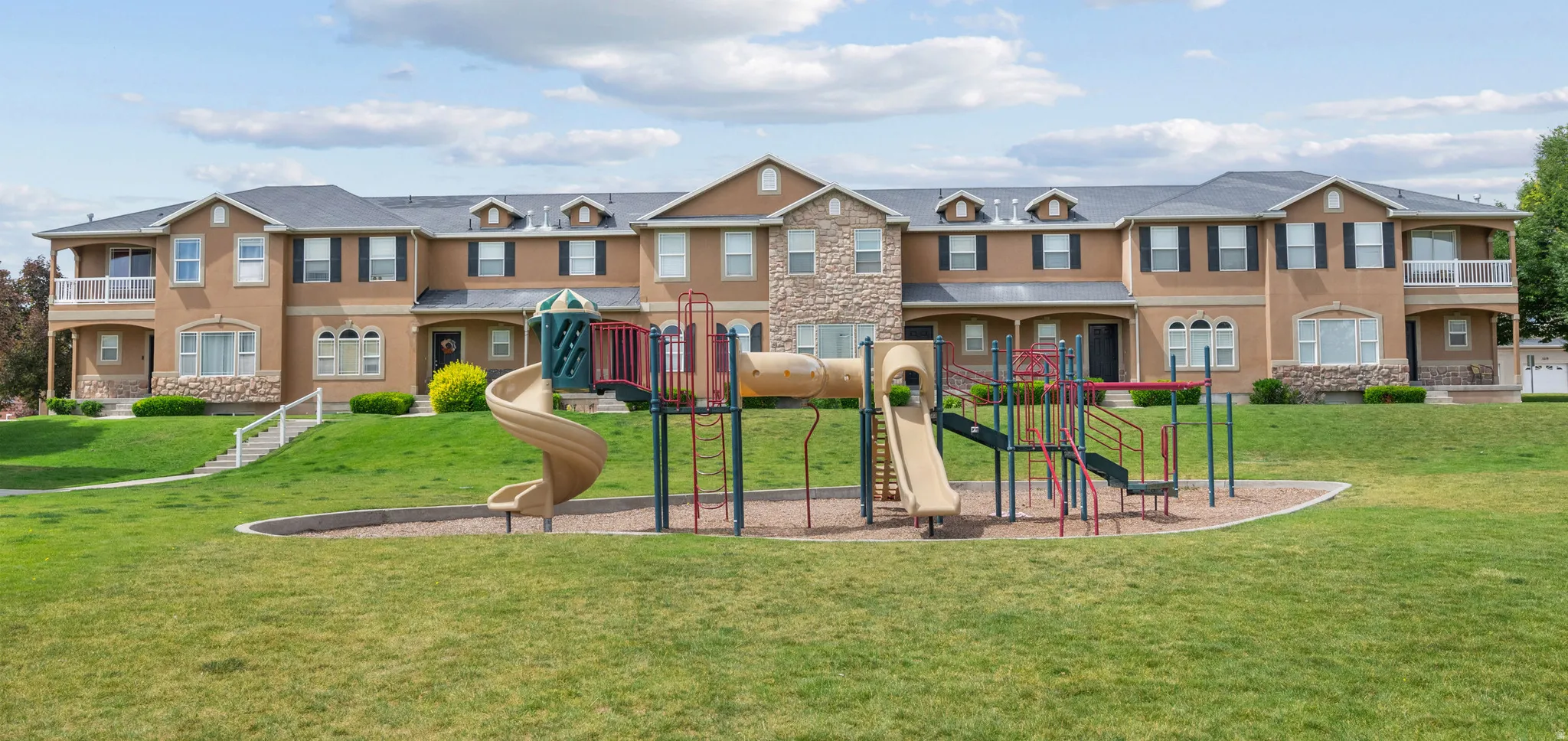 Community playground featuring multiple slides and climbing structures
