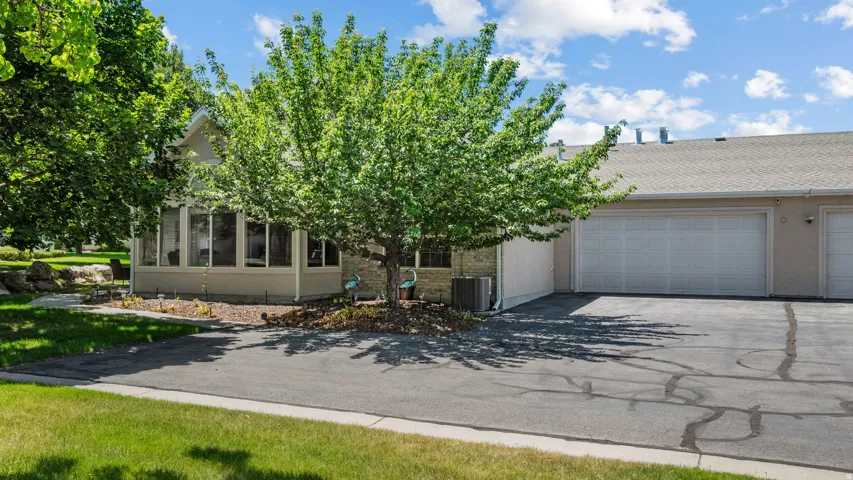 Two-car garage with white doors and asphalt driveway
