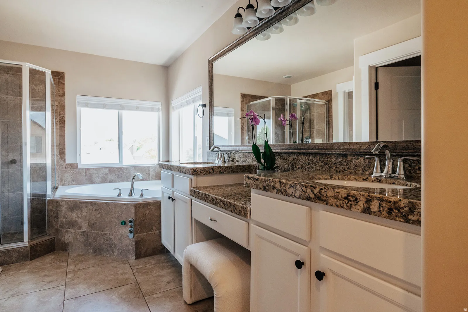 Dual vanities with granite countertops and under-mount sinks